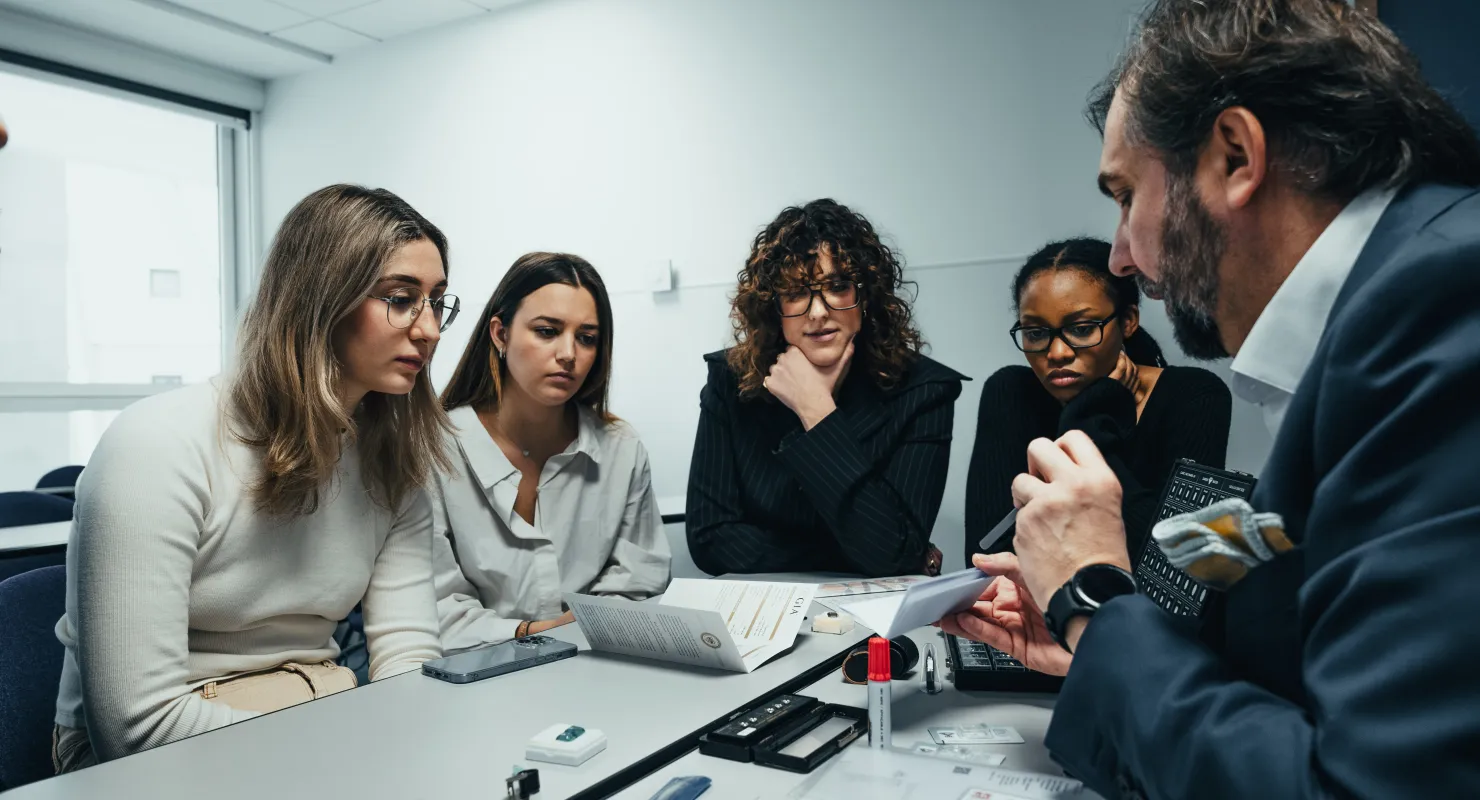 Students studying luxury management and global branding in a modern classroom setting